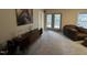 Cozy living room with carpet and a door to the backyard at 4051 Silk Hope Gum Springs Rd, Pittsboro, NC 27312