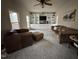 Bright living room featuring built-in shelving, neutral carpet, and comfortable seating at 4051 Silk Hope Gum Springs Rd, Pittsboro, NC 27312