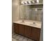 Well-lit bathroom featuring a double vanity with wooden cabinetry and a shower at 4051 Silk Hope Gum Springs Rd, Pittsboro, NC 27312