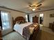 Spacious main bedroom with a ceiling fan, carpeted floor, and ensuite closet at 4051 Silk Hope Gum Springs Rd, Pittsboro, NC 27312