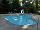 Inground pool with a pool slide, lounge chairs and mature trees for shade at 4051 Silk Hope Gum Springs Rd, Pittsboro, NC 27312