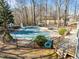 Fenced in ground pool with an slide, chairs, and a deck at 4051 Silk Hope Gum Springs Rd, Pittsboro, NC 27312