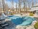Aerial view of the covered outdoor pool in the backyard, with a slide and chairs in the background at 4051 Silk Hope Gum Springs Rd, Pittsboro, NC 27312