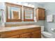 Dual vanity bathroom with granite counters, wood cabinetry, and separate mirrors at 407 Crickentree Dr, Cary, NC 27518