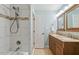 Bright bathroom featuring double sinks, granite countertops, and a tiled shower at 407 Crickentree Dr, Cary, NC 27518