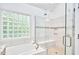 Modern bathroom with tiled shower, glass door, built-in seat, and a brick glass window at 407 Crickentree Dr, Cary, NC 27518