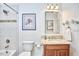 Updated bathroom with marble vanity, tile shower/tub, and decorative mirror at 407 Crickentree Dr, Cary, NC 27518