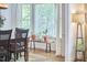 A bright and sunny bay window with several plants and white curtains in a dining room at 407 Crickentree Dr, Cary, NC 27518
