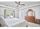 Bright bedroom featuring a ceiling fan, closet and a window offering natural light at 407 Crickentree Dr, Cary, NC 27518