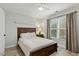 Cozy bedroom with a full bed, ceiling fan, and natural light from the window at 407 Crickentree Dr, Cary, NC 27518
