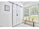 Bonus room with plank flooring, barn door, large window, and bench with plants, creating a peaceful ambiance at 407 Crickentree Dr, Cary, NC 27518