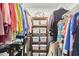 Organized closet featuring hanging clothes and shelving with storage containers at 407 Crickentree Dr, Cary, NC 27518