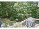 View from deck overlooking backyard with mature trees and lush greenery, offering a relaxing outdoor retreat at 407 Crickentree Dr, Cary, NC 27518