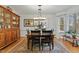 This dining room features hardwood floors, a large cabinet, and a beautiful chandelier over the table at 407 Crickentree Dr, Cary, NC 27518