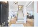 Welcoming entryway with staircase, view into the living room with fireplace, and dining room with wood table at 407 Crickentree Dr, Cary, NC 27518