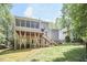 Back exterior featuring a raised deck with stairs and a screened-in porch, perfect for outdoor living and entertaining at 407 Crickentree Dr, Cary, NC 27518