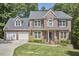 Two-story brick home with a well-manicured lawn and attached two-car garage at 407 Crickentree Dr, Cary, NC 27518