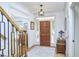 Foyer with hardwood floors, staircase with rod iron, windows with blinds, wooden door, and antique dresser at 407 Crickentree Dr, Cary, NC 27518
