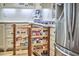 Kitchen boasts custom spice racks, white cabinets, granite counters, and stainless appliances at 407 Crickentree Dr, Cary, NC 27518