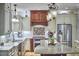 This bright kitchen features granite countertops, stainless steel appliances, and island seating at 407 Crickentree Dr, Cary, NC 27518