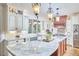 Bright kitchen featuring granite counters, a center island, and elegant pendant lighting at 407 Crickentree Dr, Cary, NC 27518
