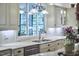 Kitchen shows white cabinetry, stainless appliances, granite counters, and natural light at 407 Crickentree Dr, Cary, NC 27518