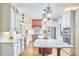 Kitchen showcases a large island, custom cabinets, stainless appliances, and hardwood flooring at 407 Crickentree Dr, Cary, NC 27518