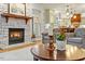 Charming living room with a stone fireplace, hardwood floors, and views of the kitchen at 407 Crickentree Dr, Cary, NC 27518