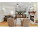 Bright living room with a stone fireplace, hardwood floors, built-in shelves and cozy furniture at 407 Crickentree Dr, Cary, NC 27518