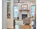 Living room with a stone fireplace, large windows and hardwood floors and a ceiling fan at 407 Crickentree Dr, Cary, NC 27518