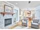 Open concept living room featuring a stone fireplace next to an open kitchen with an island at 407 Crickentree Dr, Cary, NC 27518