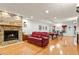 Open living room with hardwood floors, a stone fireplace, and a pool table at 407 Crickentree Dr, Cary, NC 27518