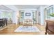 Cozy living room with hardwood floors, white walls, natural light, sofa, and view into the dining area at 407 Crickentree Dr, Cary, NC 27518