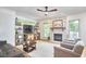 Spacious living room with a stone fireplace, hardwood floors and a large window at 407 Crickentree Dr, Cary, NC 27518