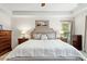 Spacious main bedroom with tray ceiling, a king bed, and a large window providing great lighting at 407 Crickentree Dr, Cary, NC 27518