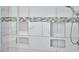 Modern tiled shower featuring a mosaic accent strip and built-in storage niches at 407 Crickentree Dr, Cary, NC 27518