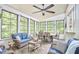 Bright sun room with tile flooring, large windows, ceiling fan, and stylish furniture, perfect for relaxing at 407 Crickentree Dr, Cary, NC 27518