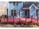 Spacious back deck of a home with blue siding and multiple windows providing great natural light at 4325 New Hope Springs Dr, Hillsborough, NC 27278