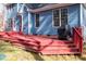 Deck stairs with grill next to a blue house with multiple windows at 4325 New Hope Springs Dr, Hillsborough, NC 27278
