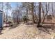 Spacious backyard featuring mature trees and a well-maintained lawn extending from the house at 4325 New Hope Springs Dr, Hillsborough, NC 27278