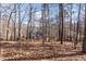 Backyard view featuring a spacious yard, utility shed, and the rear of the main house at 4325 New Hope Springs Dr, Hillsborough, NC 27278