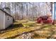 Expansive backyard featuring a utility shed near a large wooden deck and surrounding greenery at 4325 New Hope Springs Dr, Hillsborough, NC 27278