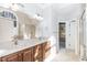 Bathroom with double vanity, large mirror, and tiled shower with glass door at 4325 New Hope Springs Dr, Hillsborough, NC 27278