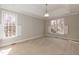 An airy bedroom with tray ceiling, large windows and neutral carpeting at 4325 New Hope Springs Dr, Hillsborough, NC 27278