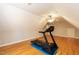 Bonus room featuring wood floors, a ceiling fan, and a treadmill on a padded mat at 4325 New Hope Springs Dr, Hillsborough, NC 27278