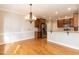 Open dining room with hardwood floors, stainless steel appliances, and pendant lighting at 4325 New Hope Springs Dr, Hillsborough, NC 27278