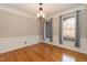 Traditional dining room with hardwood floors, crown molding, and decorative chandelier at 4325 New Hope Springs Dr, Hillsborough, NC 27278