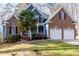 Inviting home with a well-manicured lawn, brick and siding accents, and a spacious two-car garage at 4325 New Hope Springs Dr, Hillsborough, NC 27278