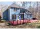 View of the back of the home, highlighting its two-story design and spacious outdoor deck at 4325 New Hope Springs Dr, Hillsborough, NC 27278