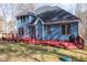 Well-maintained blue two-story home featuring a large red deck perfect for outdoor entertaining at 4325 New Hope Springs Dr, Hillsborough, NC 27278